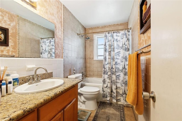 402 28th St, New Orleans, LA 70124 - bathroom with tile walls, toilet, vanity, shower / tub combo, and tile patterned flooring