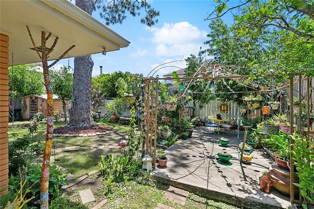 402 28th St, New Orleans, LA 70124 - view of patio featuring a storage unit, a fenced backyard, and an outdoor structure