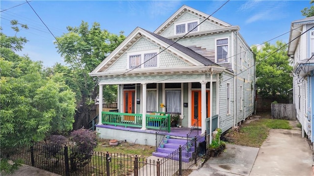 230406 Valmont St, New Orleans, LA 70115 - victorian home featuring covered porch and a fenced front yard
