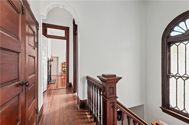 230406 Valmont St, New Orleans, LA 70115 - corridor featuring an upstairs landing, dark wood finished floors, and arched walkways