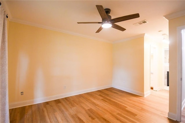 empty room with light wood finished floors, ceiling fan, baseboards, and crown molding
