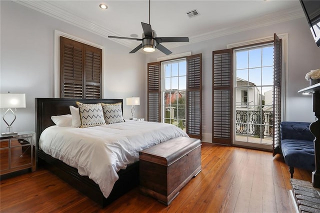 2026 Camp St, New Orleans, LA 70130 - bedroom with multiple windows, access to outside, wood-type flooring, crown molding, and recessed lighting
