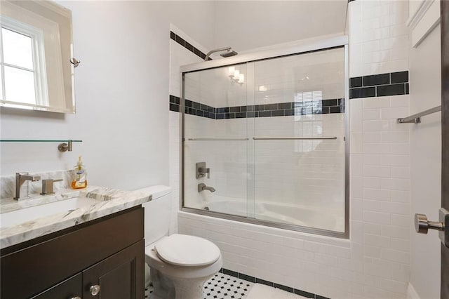 2026 Camp St, New Orleans, LA 70130 - full bath featuring toilet, bath / shower combo with glass door, tile patterned floors, and vanity