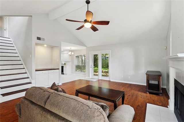 3604 Meadow Lake Dr W, Slidell, LA 70461 - living area with a fireplace with flush hearth, stairway, beamed ceiling, wood finished floors, and high vaulted ceiling