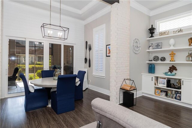 201 Jardin Loop, Covington, LA 70433 - dining room featuring dark wood-style floors, a chandelier, decorative columns, and crown molding