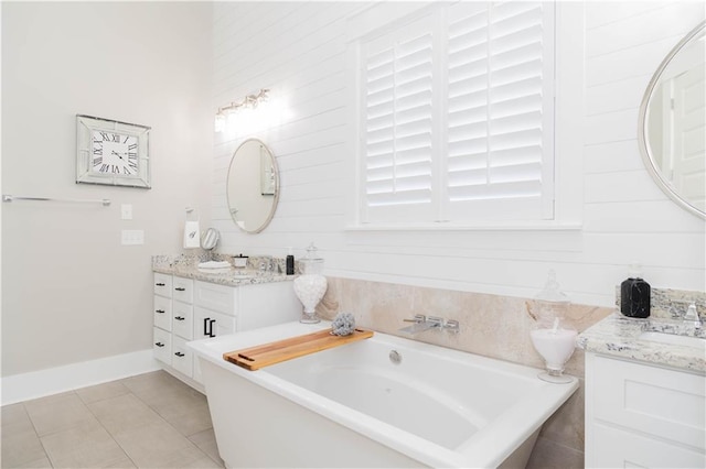 201 Jardin Loop, Covington, LA 70433 - full bath featuring tile patterned flooring, a tub, vanity, and baseboards
