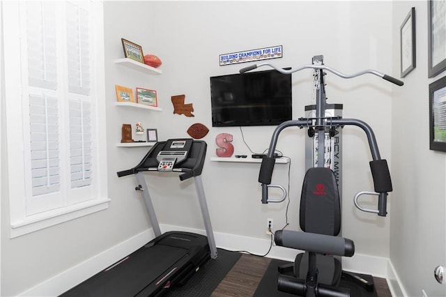 201 Jardin Loop, Covington, LA 70433 - workout room with baseboards and dark wood-style floors