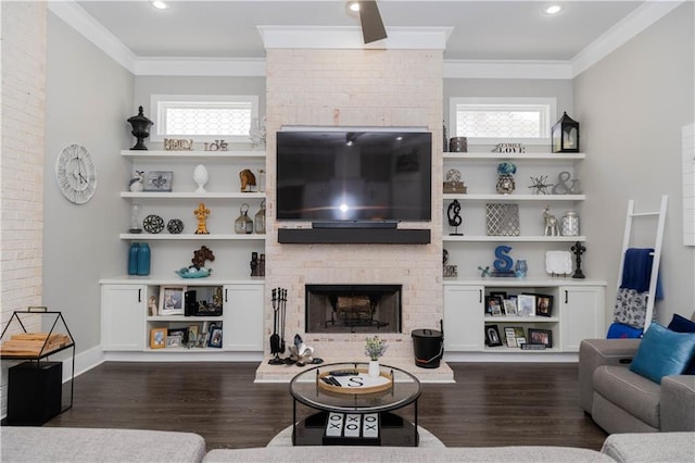 201 Jardin Loop, Covington, LA 70433 - living room with a brick fireplace, plenty of natural light, dark wood finished floors, ornamental molding, and recessed lighting