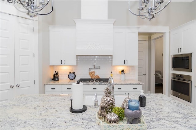 201 Jardin Loop, Covington, LA 70433 - kitchen featuring a chandelier, appliances with stainless steel finishes, and tasteful backsplash