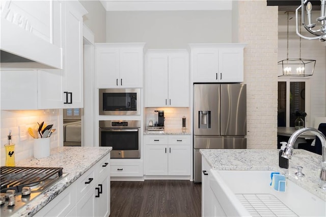 201 Jardin Loop, Covington, LA 70433 - kitchen featuring appliances with stainless steel finishes, a sink, white cabinets, and decorative backsplash