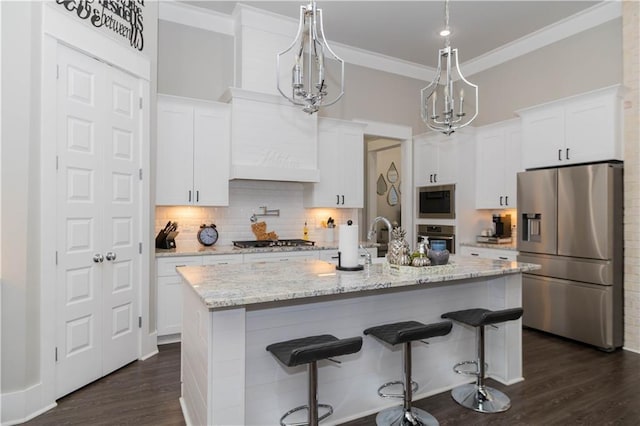 201 Jardin Loop, Covington, LA 70433 - kitchen with stainless steel appliances, a chandelier, decorative backsplash, white cabinetry, and ornamental molding