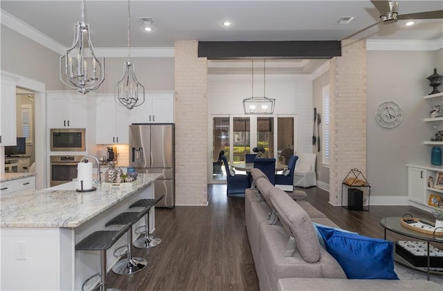 201 Jardin Loop, Covington, LA 70433 - living area with a chandelier, dark wood finished floors, crown molding, and ceiling fan