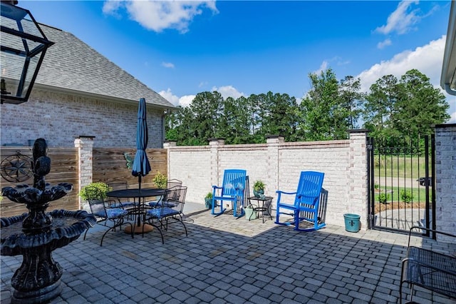 201 Jardin Loop, Covington, LA 70433 - view of patio featuring outdoor dining space and a gate