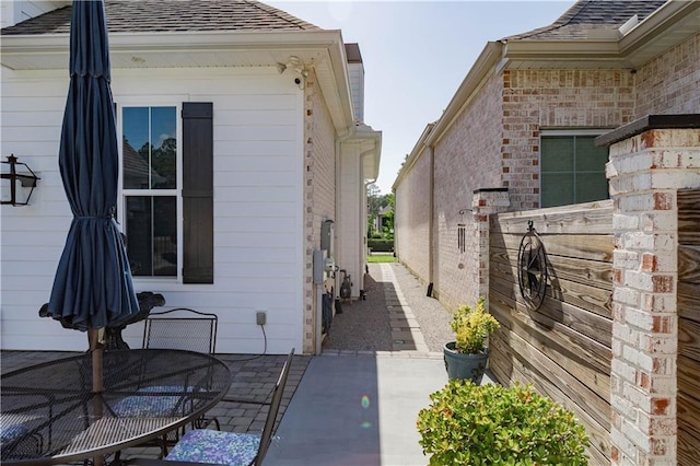 201 Jardin Loop, Covington, LA 70433 - view of side of property featuring a patio, a shingled roof, and outdoor dining area