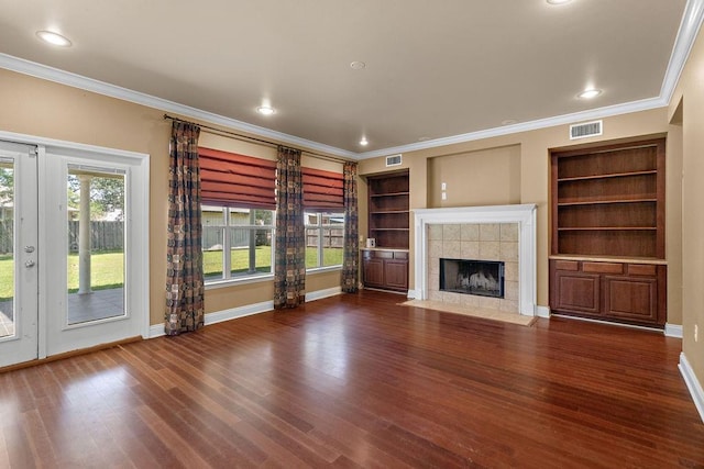 1134 Belair Blvd, Slidell, LA 70460 - unfurnished living room with crown molding, a tiled fireplace, wood finished floors, baseboards, and recessed lighting