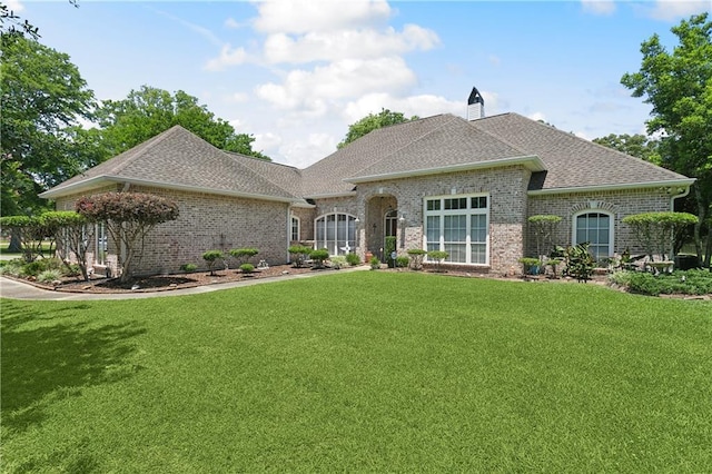 42160 Jefferson Dr, Hammond, LA 70403 - french country inspired facade with a front lawn, roof with shingles, and brick siding