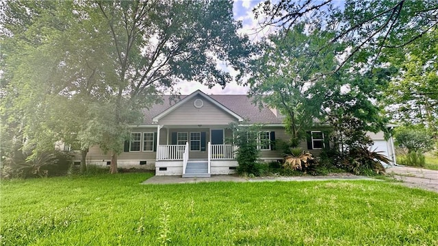 back of house with crawl space, covered porch, a lawn, and a garage