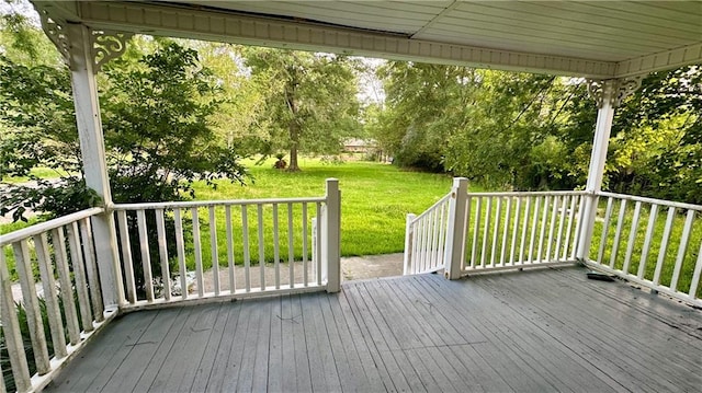 wooden terrace with a yard