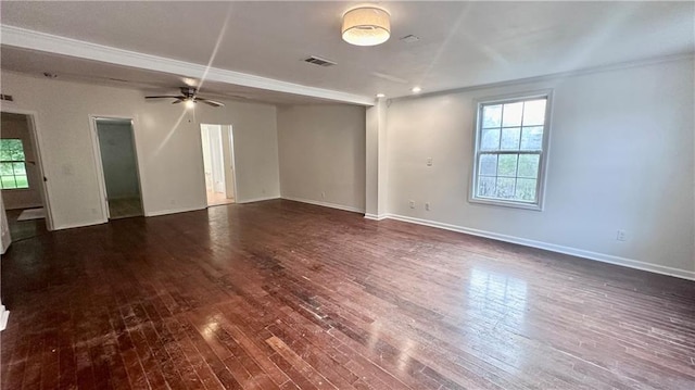 unfurnished living room featuring healthy amount of natural light, dark wood-style floors, baseboards, ceiling fan, and ornamental molding