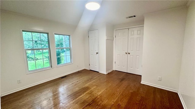 unfurnished bedroom with dark wood finished floors and baseboards