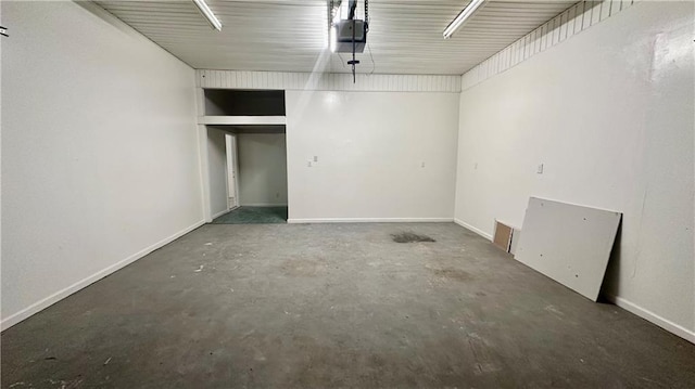 garage with a garage door opener and baseboards