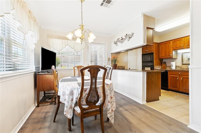 3117 Texas Ave, Kenner, LA 70065 - dining space with a chandelier, light wood-style floors, and ornamental molding