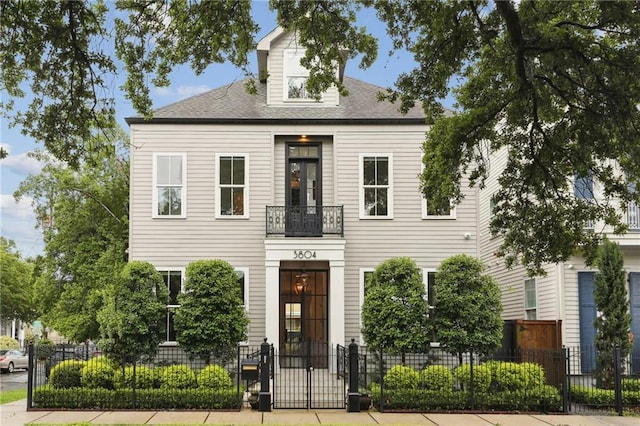 3804 Prytania St, New Orleans, LA 70115 - view of front of house featuring a fenced front yard, a gate, a balcony, and roof with shingles