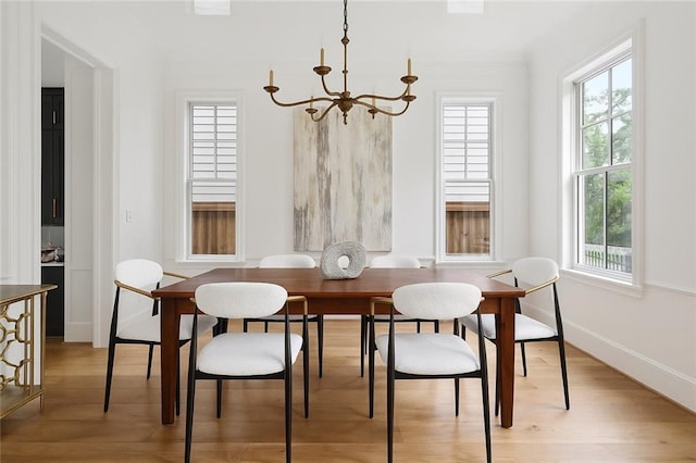 3804 Prytania St, New Orleans, LA 70115 - dining area featuring a chandelier, healthy amount of natural light, and light wood-style flooring