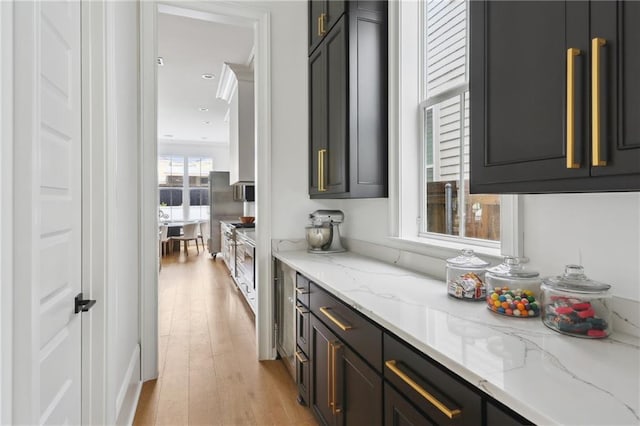 3804 Prytania St, New Orleans, LA 70115 - kitchen with light wood-type flooring and light stone counters