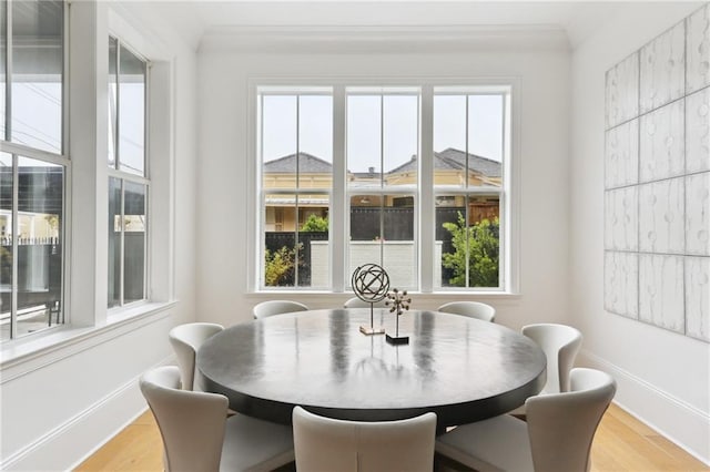 3804 Prytania St, New Orleans, LA 70115 - dining room with wood finished floors, baseboards, and crown molding