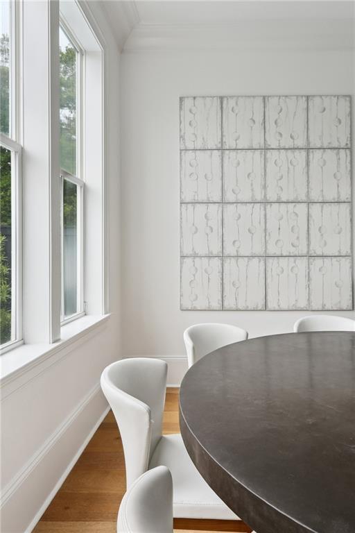 3804 Prytania St, New Orleans, LA 70115 - dining room featuring crown molding, wood finished floors, and baseboards