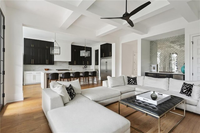 3804 Prytania St, New Orleans, LA 70115 - living room featuring coffered ceiling, a ceiling fan, light wood-type flooring, and beamed ceiling