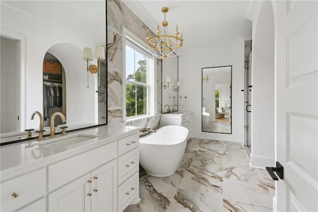 3804 Prytania St, New Orleans, LA 70115 - full bath with a chandelier, a freestanding bath, marble tiled floors, two vanities, and crown molding