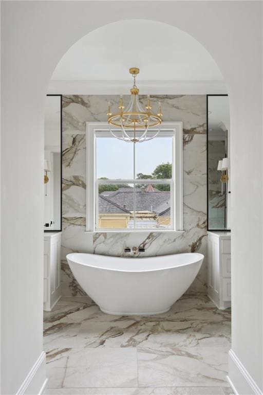 3804 Prytania St, New Orleans, LA 70115 - full bath featuring marble tiled floors, a chandelier, and a soaking tub