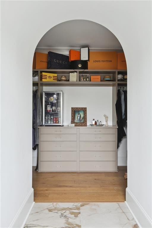 3804 Prytania St, New Orleans, LA 70115 - bar with arched walkways, baseboards, and wood finished floors