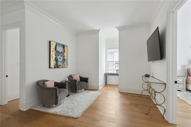 3804 Prytania St, New Orleans, LA 70115 - living area with crown molding, light wood-style flooring, and baseboards