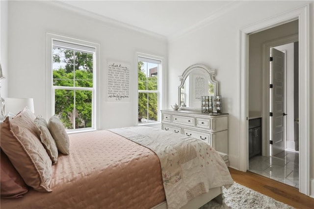3804 Prytania St, New Orleans, LA 70115 - bedroom featuring ornamental molding, light wood-style flooring, and ensuite bath