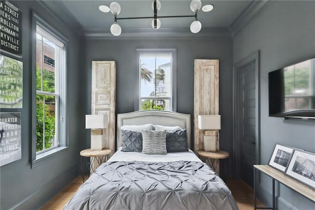 3804 Prytania St, New Orleans, LA 70115 - bedroom with ornamental molding, multiple windows, and wood finished floors