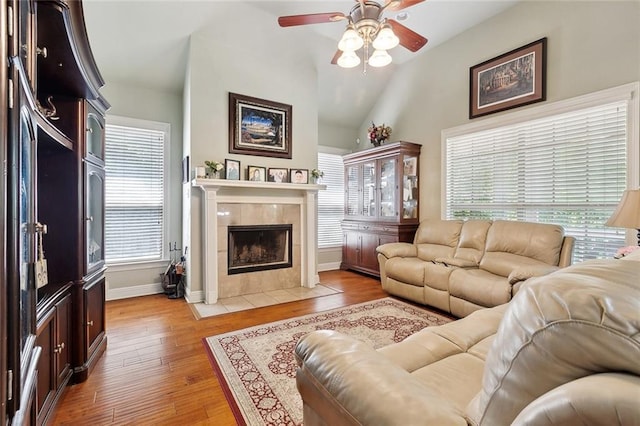 5 Rhonda Ct, Covington, LA 70433 - living area with ceiling fan, a tile fireplace, lofted ceiling, light wood-style floors, and baseboards