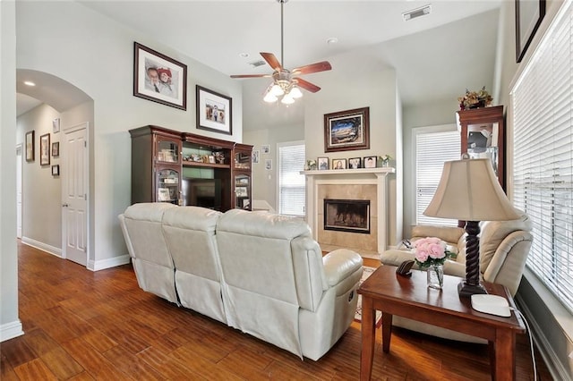 5 Rhonda Ct, Covington, LA 70433 - living room featuring ceiling fan, arched walkways, wood finished floors, baseboards, and healthy amount of natural light