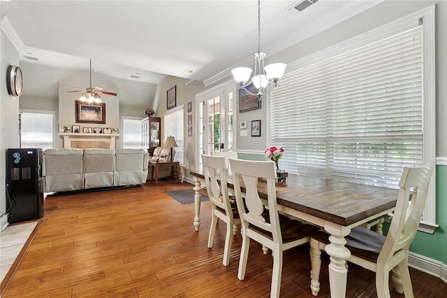 5 Rhonda Ct, Covington, LA 70433 - dining area featuring a chandelier, ceiling fan, wood finished floors, and vaulted ceiling