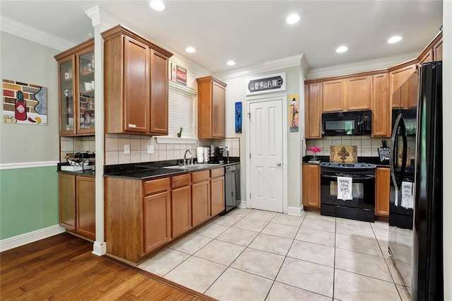 5 Rhonda Ct, Covington, LA 70433 - kitchen featuring black appliances, ornamental molding, decorative backsplash, glass insert cabinets, and brown cabinets