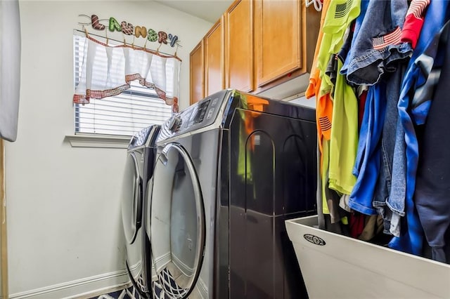 5 Rhonda Ct, Covington, LA 70433 - laundry room featuring washing machine and dryer, cabinet space, and baseboards