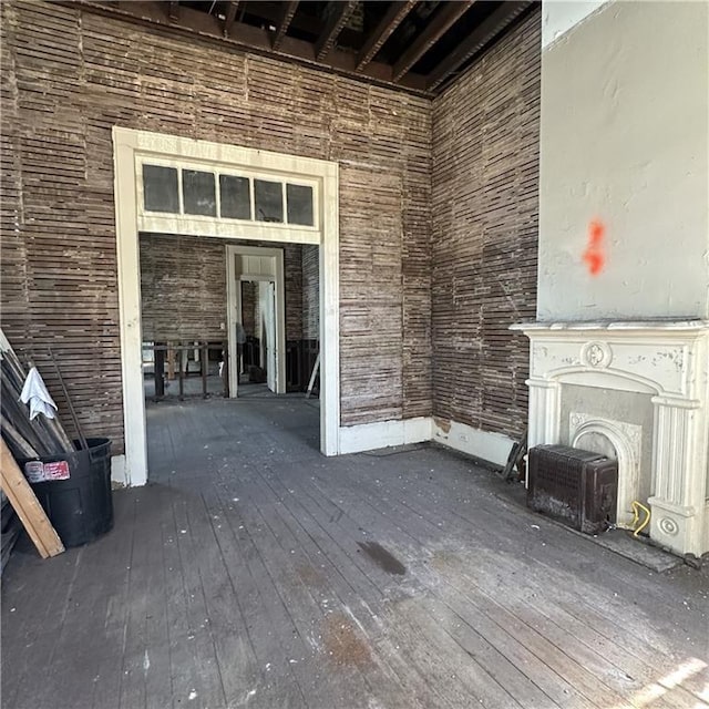 1919-1921 Bayou Rd, New Orleans, LA 70116 - unfurnished living room featuring hardwood / wood-style flooring and a fireplace