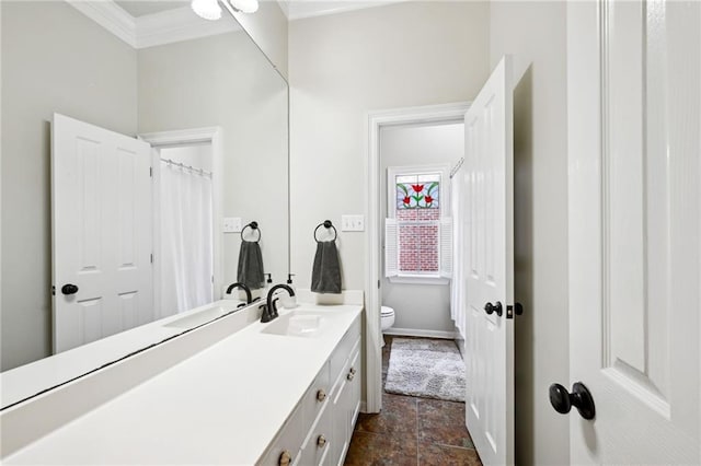61180 Doe Run Dr, Amite, LA 70422 - bathroom featuring toilet, crown molding, vanity, stone finish floors, and baseboards