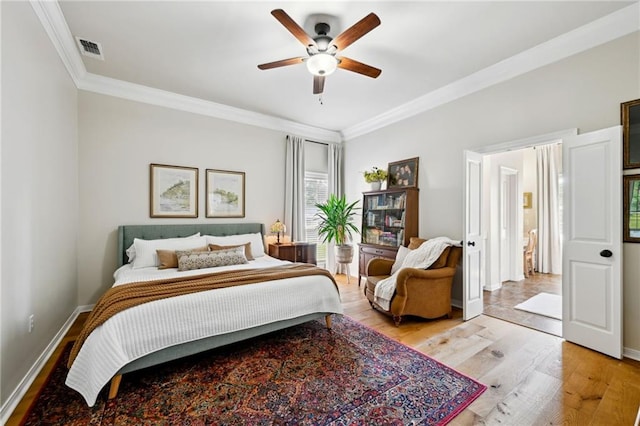 61180 Doe Run Dr, Amite, LA 70422 - bedroom featuring crown molding, light wood-style floors, baseboards, and ceiling fan