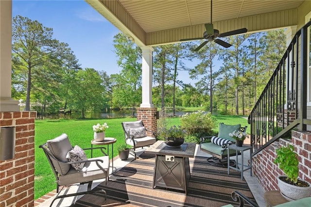 61180 Doe Run Dr, Amite, LA 70422 - deck with an outdoor living space, ceiling fan, a lawn, a water view, and view of scattered trees