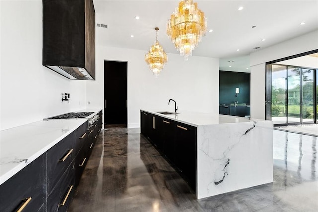 67 Hummingbird Rd, Covington, LA 70433 - kitchen with a chandelier, modern cabinets, a sink, dark cabinets, and recessed lighting