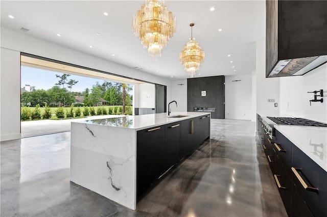67 Hummingbird Rd, Covington, LA 70433 - kitchen featuring modern cabinets, a chandelier, concrete flooring, a sink, and dark cabinetry