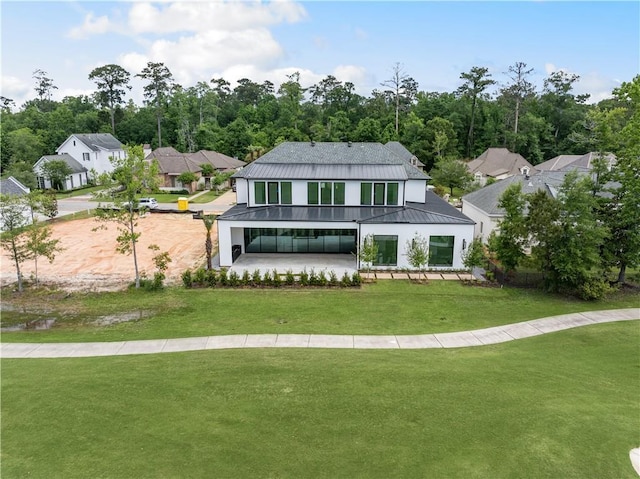 67 Hummingbird Rd, Covington, LA 70433 - view of front of house featuring a front yard, metal roof, a standing seam roof, and a patio